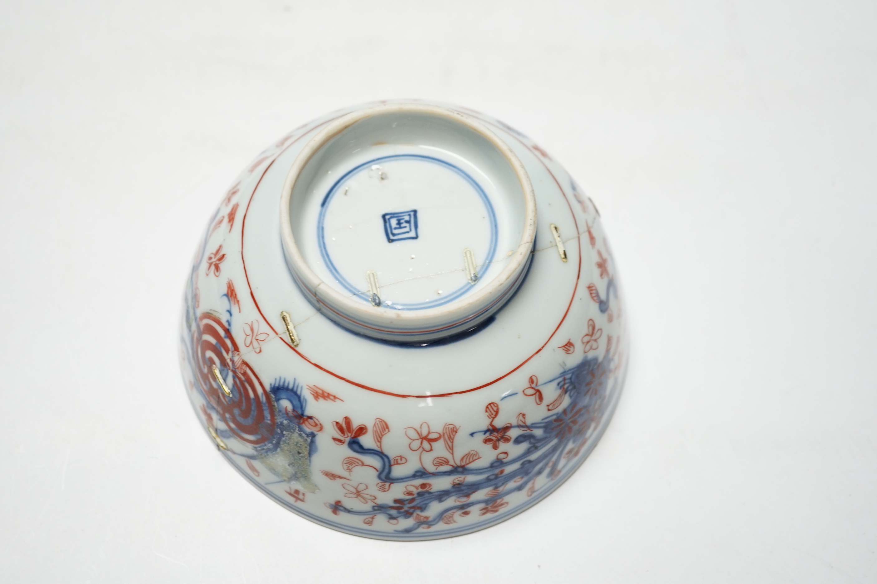 An 18th century Japanese Imari sake flask and a Chinese clobbered blue and white bowl (a.f), tallest 20cm